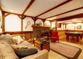 Warm rustic furnished living room with a fireplace and pool table