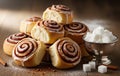 Warm rustic kitchen atmosphere with stack of cinnamon rolls and sugar cubes prepared for sweet indulgent treat Royalty Free Stock Photo