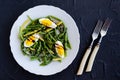 Warm salad with cooked green beans and boiled eggs