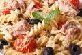 Warm salad fusilli pasta, tuna and tomatoes macro. horizontal