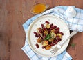 Warm salad of grilled Jerusalem artichoke and boiled red beans with olive oil and vinegar dressing on a white clay plate Royalty Free Stock Photo