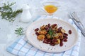 Warm salad of grilled Jerusalem artichoke and boiled red beans with olive oil and vinegar dressing on a white clay plate Royalty Free Stock Photo