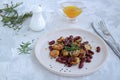 Warm salad of grilled Jerusalem artichoke and boiled red beans with olive oil and vinegar dressing on a white clay plate Royalty Free Stock Photo