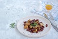 Warm salad of grilled Jerusalem artichoke and boiled red beans with olive oil and vinegar dressing on a white clay plate Royalty Free Stock Photo