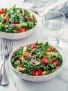 Warm salad with tuna, arugula, tomato, bean, pasta