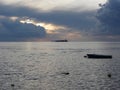 Warm sea sunset with cargo ship at the horizon . Giants cumulonimbus clouds are in the sky. Tuscany, Italy Royalty Free Stock Photo