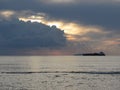 Warm sea sunset with cargo ship at the horizon . Giants cumulonimbus clouds are in the sky. Tuscany, Italy Royalty Free Stock Photo