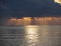 Warm sea sunset with giants cumulonimbus clouds in the sky and sun rays through . Tuscany, Italy Royalty Free Stock Photo