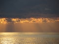 Warm sea sunset with giants cumulonimbus clouds in the sky and sun rays through . Tuscany, Italy Royalty Free Stock Photo