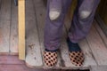 Warm shabby slippers on the background of old wooden floor. Royalty Free Stock Photo