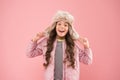 Warm smile. happy child pink background. warm clothes for cold season. kid fashion. trendy girl look like hipster Royalty Free Stock Photo