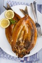 Warm smoked kipper with lemon and parsley on a plate Royalty Free Stock Photo