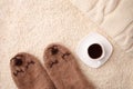 Warm soft blanket, cup of hot espresso coffee, woolen socks. Winter fall autumn cozy still life. Top view point. Copy space.