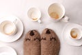 Warm soft blanket, many empty cups of espresso coffee, woolen socks. Winter fall autumn cozy still life. Lazy sleepy weekend