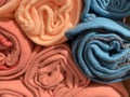 Warm soft rugs of various pastel colors rolled into rollers. End view. Texture, background Royalty Free Stock Photo