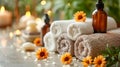 Warm Spa Ambiance with Candles, Towels, and Orange Flowers Royalty Free Stock Photo