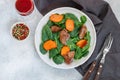 Warm spinach salad with chicken liver and baked pumpkin