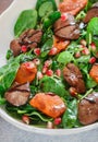 Warm spinach salad with chicken liver, baked pumpkin and pomegranate