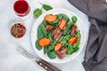 Warm spinach salad with chicken liver and baked pumpkin with spices and balsamic