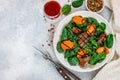 Warm spinach salad with chicken liver and baked pumpkin with spices and balsamic