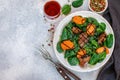 Warm spinach salad with chicken liver and baked pumpkin with spices and balsamic