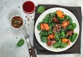 Warm spinach salad with chicken liver and baked pumpkin with spices and balsamic