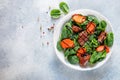 Warm spinach salad with chicken liver and baked pumpkin with spices and balsamic