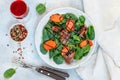 Warm spinach salad with chicken liver and baked pumpkin with spices and balsamic