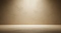 Warm spotlight illuminates a textured beige wall and concrete floor in a minimalist studio setting Royalty Free Stock Photo