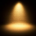 A warm spotlight illuminates a textured burlap surface, creating a dramatic contrast Royalty Free Stock Photo