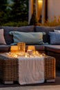 Summer night in the garden with trendy furniture, lights, lanterns and candles Royalty Free Stock Photo