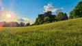 Altfinkenstein - Warm sun beams through Idyllic alpine meadow during sunset with scenic view of Finkenstein Castle