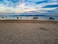 Warm sun light sundown sunset boat ship laying beach sand islands tropical orange thailand asia water mirroring evening