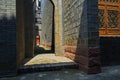 Warm sunlight in alley between old-fashioned buildings Royalty Free Stock Photo