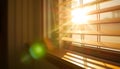 Warm sunlight streams through wooden blinds, casting geometric shadows and creating a cozy interior Royalty Free Stock Photo