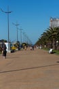 Warm sunny spring day on a seaside resort. Promenade walking lane. Batumi, Georgia, March 2022
