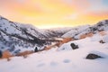 warm sunrise hues on a snow-filled valley