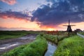 Warm sunrise over Dutch windmill and river Royalty Free Stock Photo