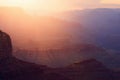 Warm sunset light spills through the Grand Canyon