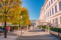 Warm sunset over busy with tourists streets at Alberina, Palmenhaus and Neue Burg Palace garden, near Hofburg Palace in historical