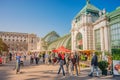 Warm sunset over busy with tourists streets at Alberina, Palmenhaus and Neue Burg Palace garden, near Hofburg Palace in historical