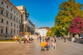 Warm sunset over busy with tourists streets at Alberina, Palmenhaus and Neue Burg Palace garden, near Hofburg Palace in historical