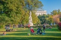 Warm sunset over busy with tourists streets at Alberina, Palmenhaus and Neue Burg Palace garden, near Hofburg Palace in historical