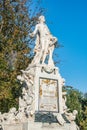 Warm sunset over Mozart monument in front of Palmenhaus, near Neue Burg and Hofburg Palaces garden, in historical downtown of