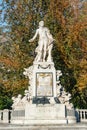 Warm sunset over Mozart monument in front of Palmenhaus, near Neue Burg and Hofburg Palaces garden, in historical downtown of