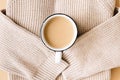 Warm sweater and a cup of hot coffee, cappuccino, milk tea. Autumn mood, minimalism. The concept of home comfort Royalty Free Stock Photo