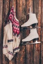 Warm sweater and pair of white skates hanging