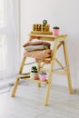 Warm sweaters lie on a wooden shelf.