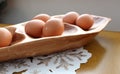 Warm-tone wood platter with fresh eggs