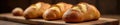 Warm toned image, multiple bread loaves on wooden board, wooden, golden, display